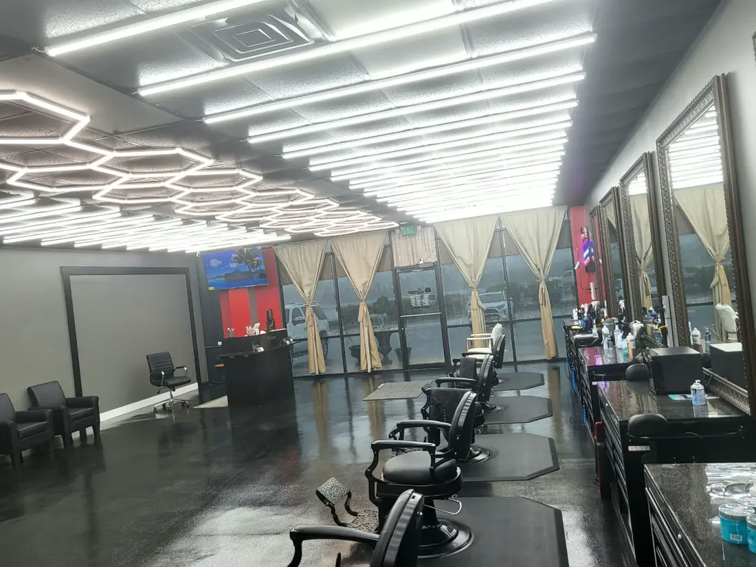 The row of barber chairs and mirrors along the wall