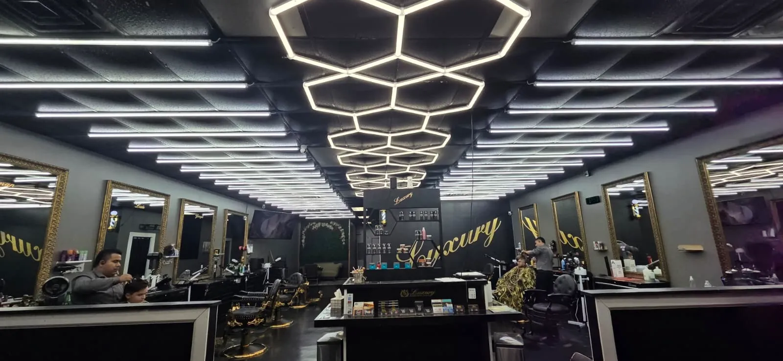 The full floor: mirrors down both walls under hexagon lighting